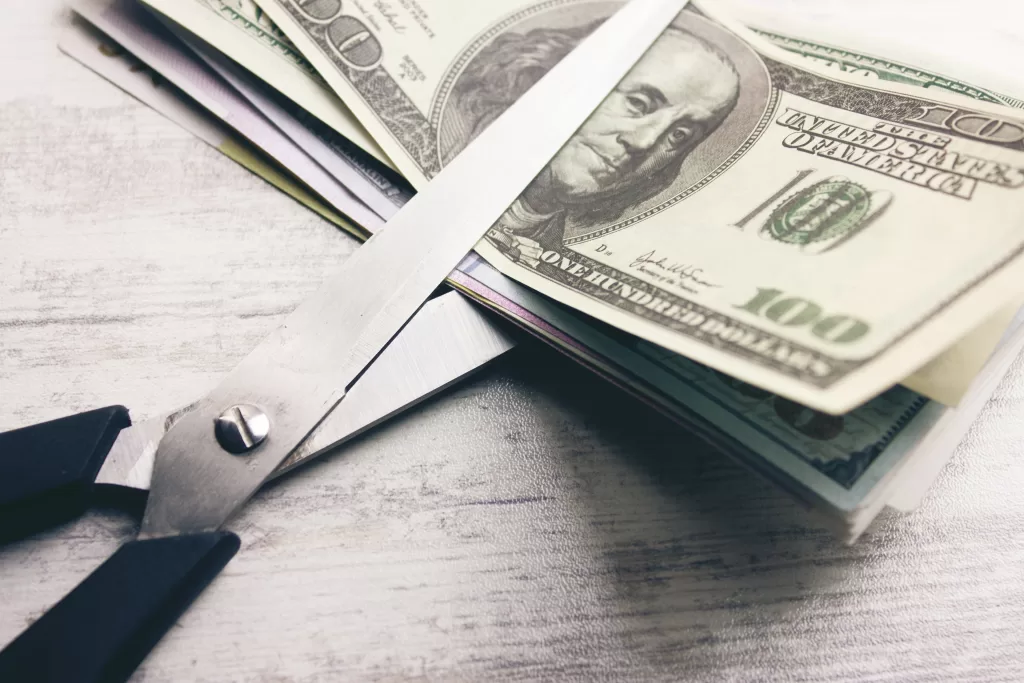 Dollar banknotes with scissors lying