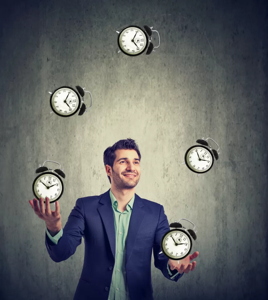 business man juggling his time alarm clocks